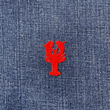Red lobster patch on blue denim fabric