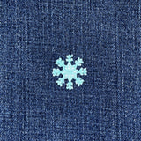 Snowflake design on a blue denim fabric background