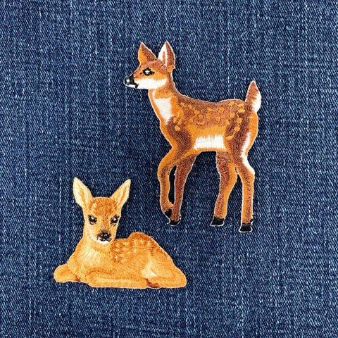 Two deer patches on a denim background