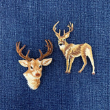Embroidered deer patches on a blue denim fabric background