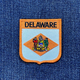 Delaware state patch on a blue denim background