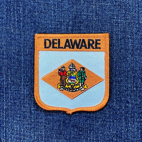 Delaware state patch on a blue denim background