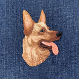 Embroidered german shepherd dog patch on a denim background