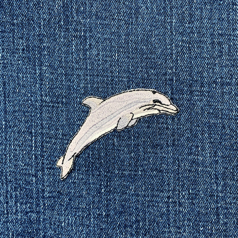 Dolphin patch on a denim background