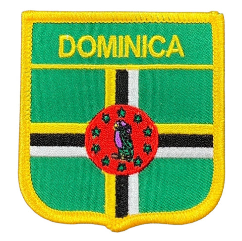 A shield-shaped embroidered patch with the name 'DOMINICA' at the top. 