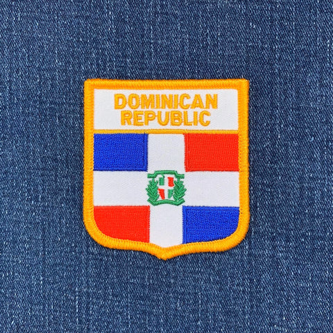 Embroidered patch of the Dominican Republic flag on a blue denim background
