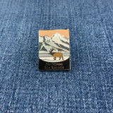 Pin with National Elk Refuge mountain and elk design on a denim background