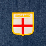 white and red england patch on a denim background