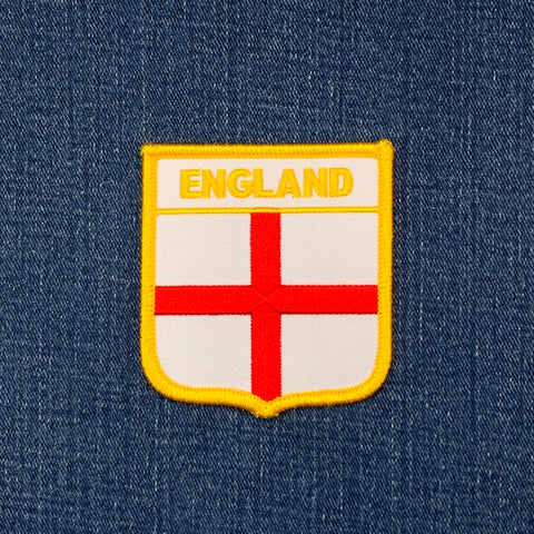 white and red england patch on a denim background