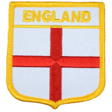 A shield-shaped embroidered patch with a red cross on a white background, bordered with yellow, and the text 'ENGLAND' at the top.