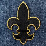 extra large black and gold fleur-de-lis patch on denim fabric