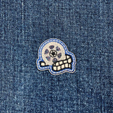 film reel patch with colorful design on a denim background