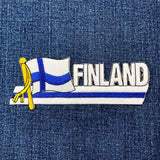 Embroidered patch of a flag with 'FINLAND' text on denim fabric