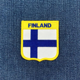 Finland flag patch on a denim background