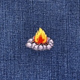 a camp fire pit patch on a denim background