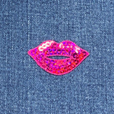 Pink sequin lips patch on denim fabric