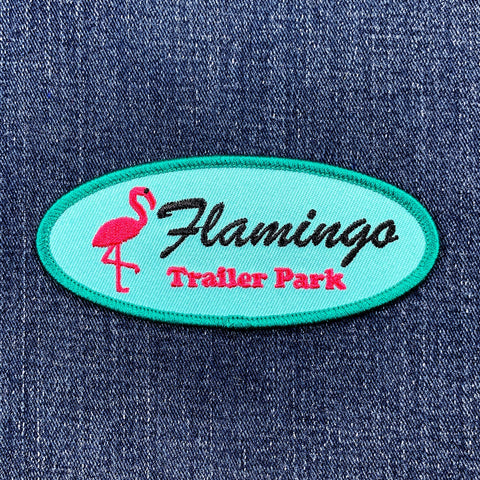 Embroidered patch with 'Flamingo Trailer Park' design on a denim background