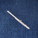 flute patch on a blue denim background