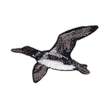 An embroidered patch of a flying loon duck, featuring black and white feather details with a small red eye accent, shown on a plain white background.