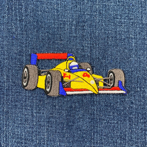 Embroidered race car patch on denim fabric