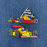 two patches of formula 1 race cars on a denim background