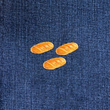 Three bread patches on a blue denim fabric