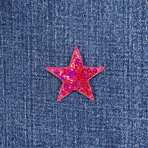 Pink sequin star patch on blue denim fabric
