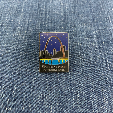 Pin with Gateway Arch design on a denim background
