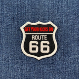 Patch with 'Get Your Kicks On Route 66' text on denim fabric