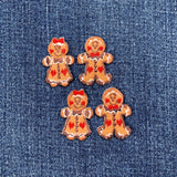 Four gingerbread-themed patches on a denim background