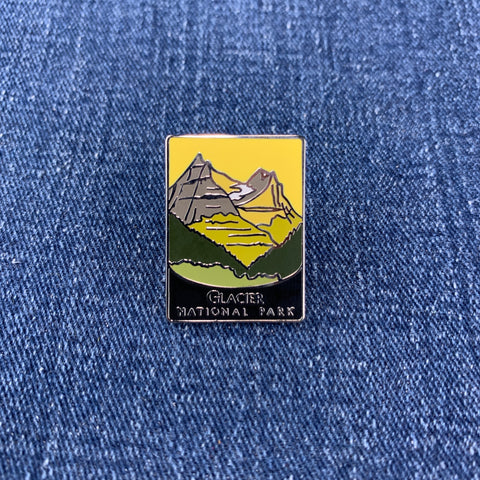 Pin with glacier national park mountain design on a denim background