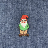 gnome patch with a red hat and white beard on a denim background