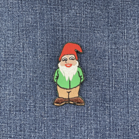 gnome patch with a red hat and white beard on a denim background