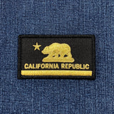 Black and gold California Republic patch with bear and star design on blue denim fabric