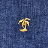 Gold palm tree patch on blue denim fabric