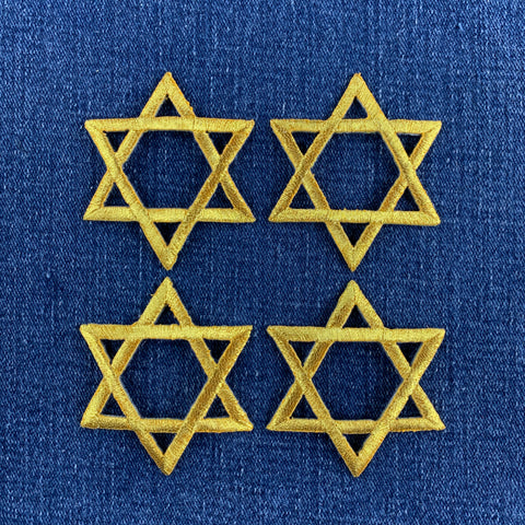 4 gold star of David patches on a denim background