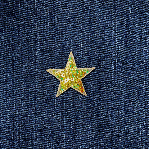 Star-shaped gold sequin patch on a denim background