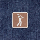 Patch of a golfer on a denim fabric background