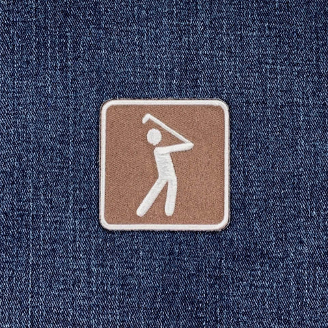 Patch of a golfer on a denim fabric background