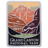 A rectangular embroidered patch depicting the Grand Canyon in shades of orange, brown, and purple. The bottom section is black with the text 'GRAND CANYON NATIONAL PARK' stitched in gray.
