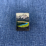 Pin with Grand Teton National Park design on a blue denim background