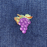 Embroidered grape bunch patch on denim fabric