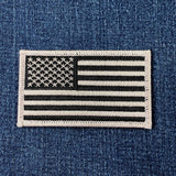 Gray and black American flag patch on a denim background