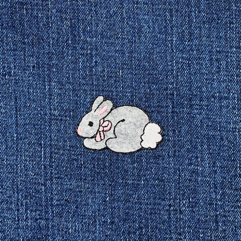 Embroidered bunny patch on denim fabric