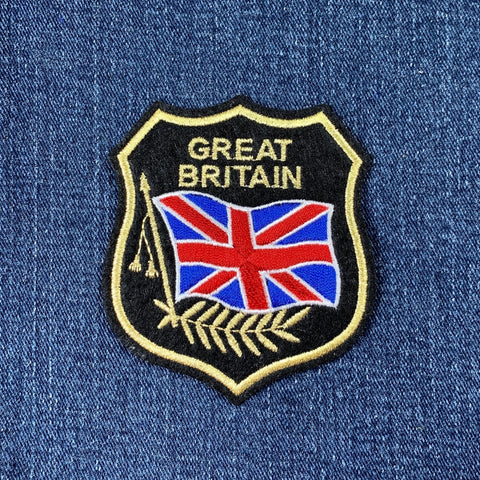 Embroidered patch with 'Great Britain' text and Union Jack on blue denim background