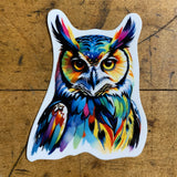 A colorful vinyl decal of a great horned owl on a wood background