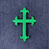 Green cross-shaped patch on a blue denim background