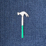 Embroidered hammer patch on denim fabric