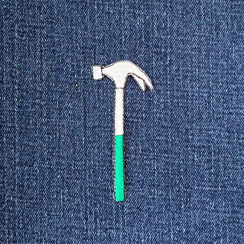 Embroidered hammer patch on denim fabric