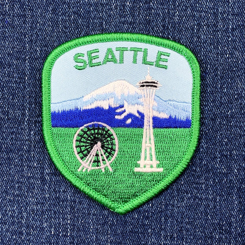 Embroidered patch with Seattle landmarks on a denim background